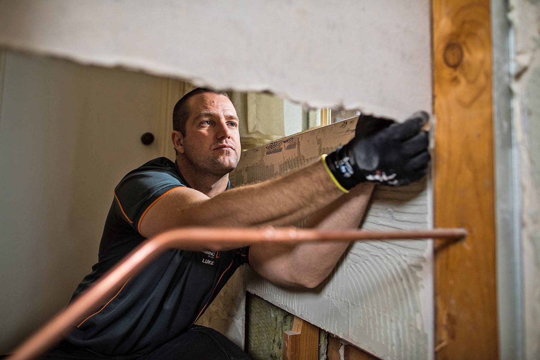 Builder's trade apprentice working with plasterboard