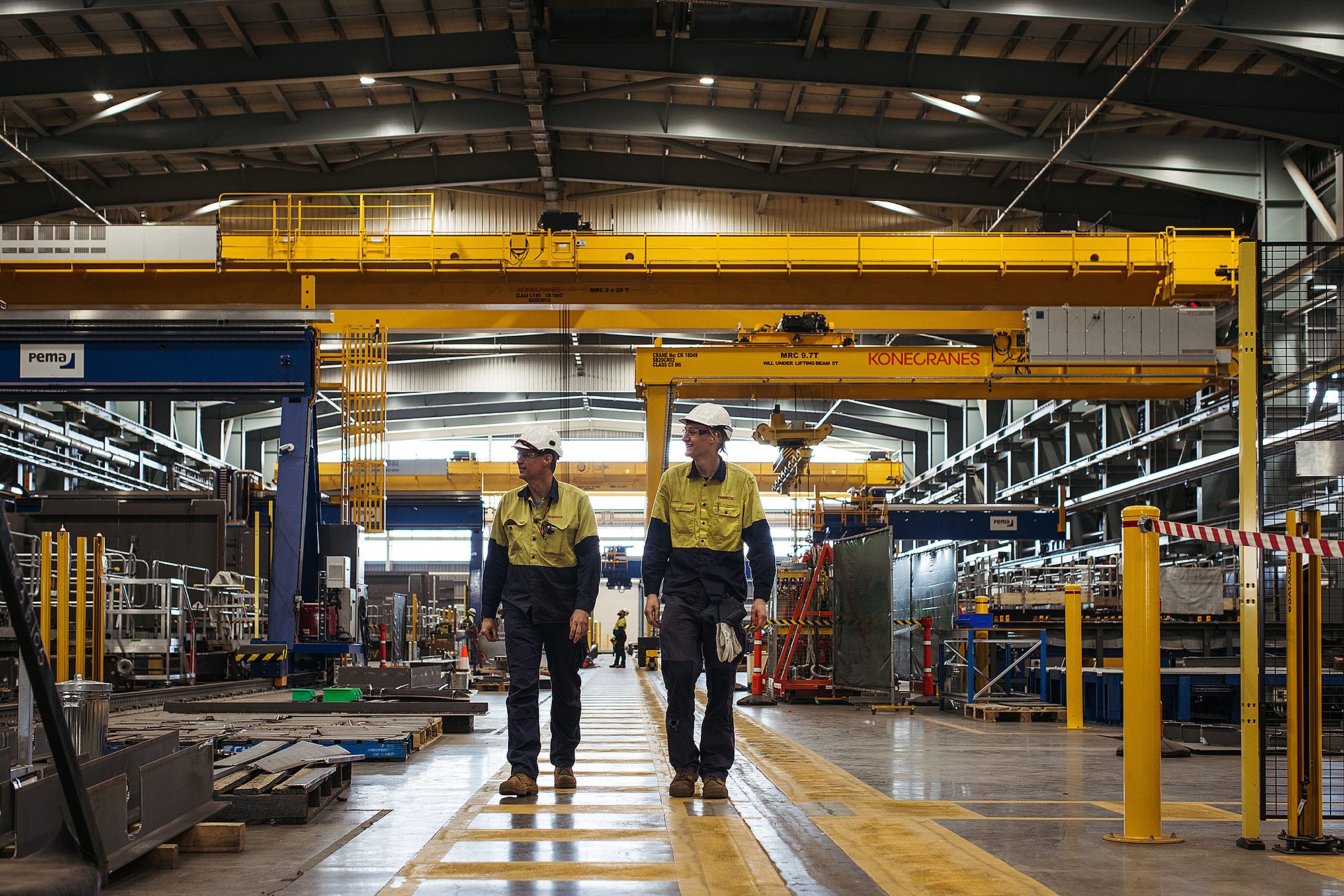 Two defence industry workers walking through BAE defence systems